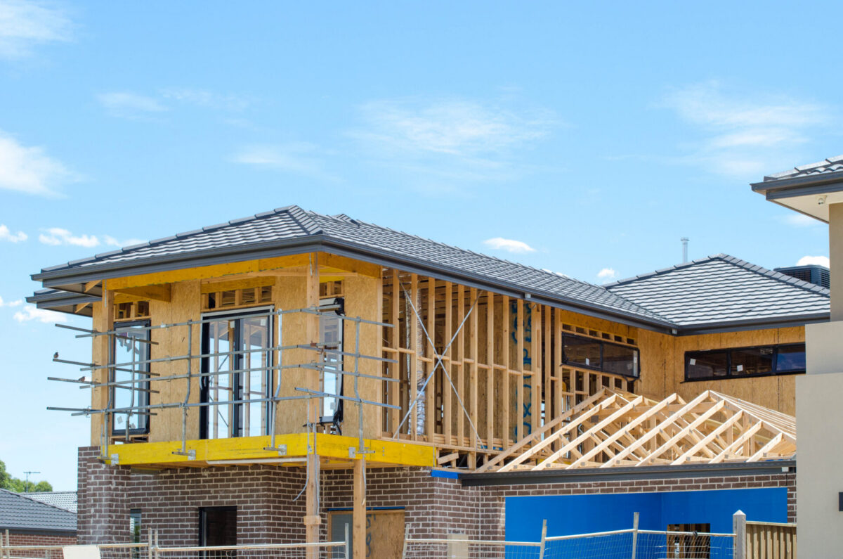 The structure of a two-story residential suburban house under construction. Concept of real estate development, self build a home, new Australian suburb, and homeownership. Melbourne, VIC Australia.